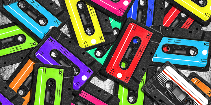 different coloured cassette tapes in a pile