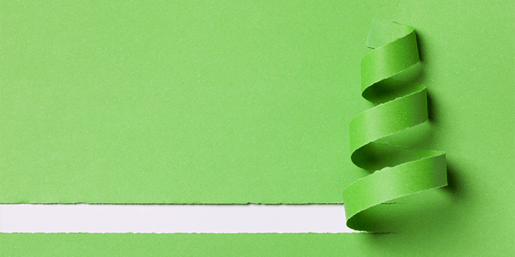 A sheet of green material with a stripe being ripped in a line