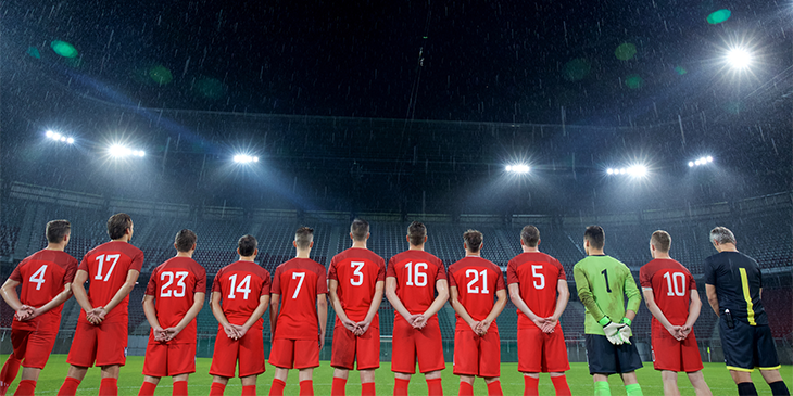 Line of football players from behind showing their shirt numbers