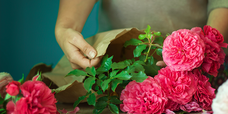 A bouquet of flowers being worked on