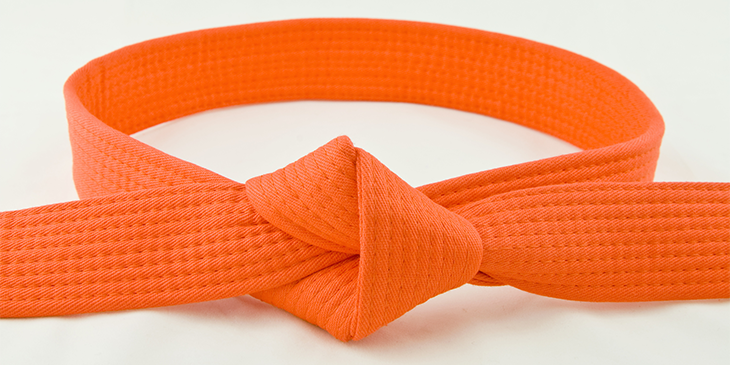 An orange belt tied together with a knot