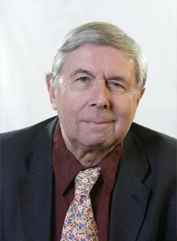 A headshot of Professor Hugh Burkhardt in-front of a white background