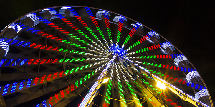 A brightly lit rotating ferris wheel
