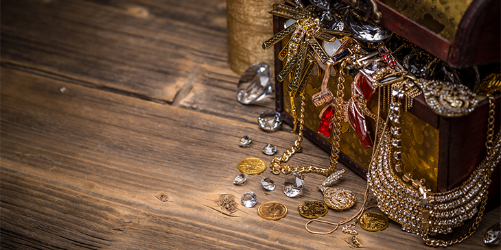 Overflowing treasure chest in a wooden room