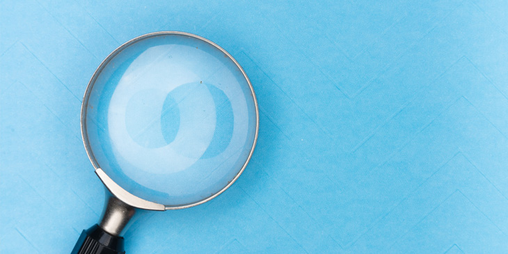 A magnifying glass on a blue background