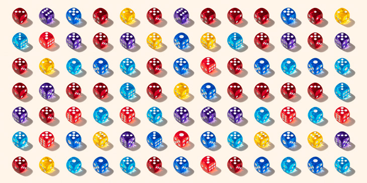 A range of dice laid out in a grid, each die is a different colour and showing a range of numbered side