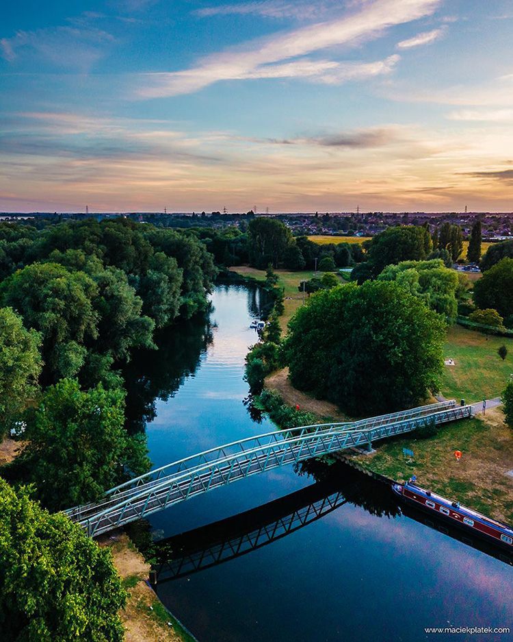 An aerial view photo of a bridge crossing a river