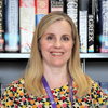 Carrie in-front of a bookcase