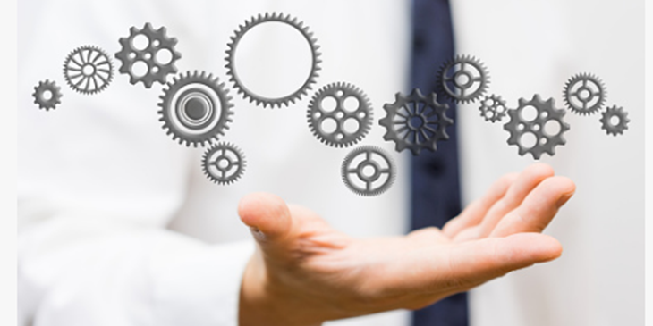 assorted cogs and gear wheels floating above an open hand