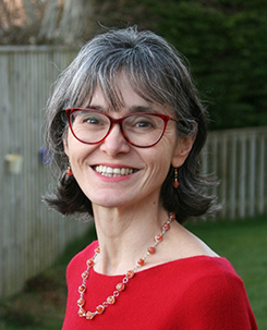 A headshot of Cristina Mio in a garden