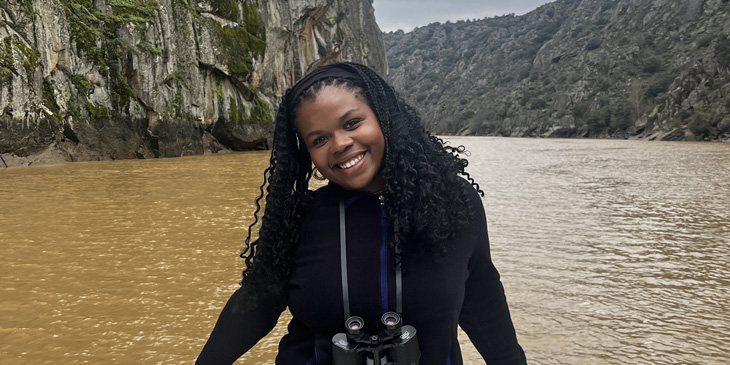 Ademipo on a boat sailing on a river