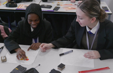 Two secondary school students using mathematics manipulatives together