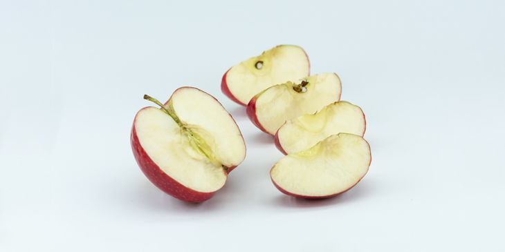 Half an apple, with the other half cut into four pieces