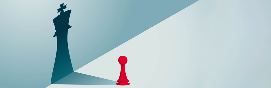 A red Pawn chess piece with a shadow that forms the shape of a King piece