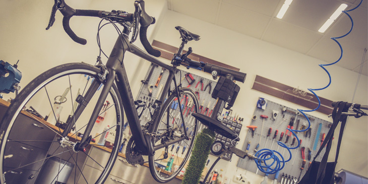 A bike clamped in the air inside a workshop