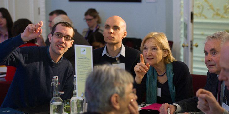 A group around a table discuss the Framework