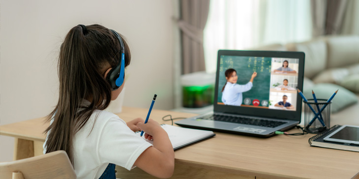 Young girl infront of her laptop learning online