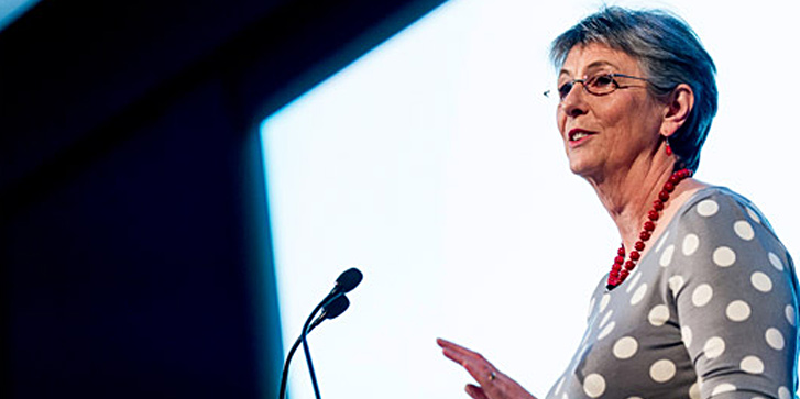 Lynne McClure at a podium giving a speech