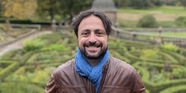 Headshot of Rachad Zaki, with a garden in the background