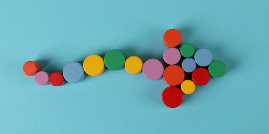 Multiple coloured blocked from above which are positioned to make an arrow