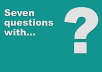 A teal background with the text, 'Seven questions with...' and a giant question mark