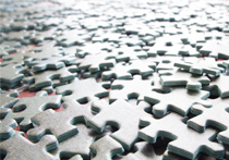Blank jigsaw pieces spread out across a surface