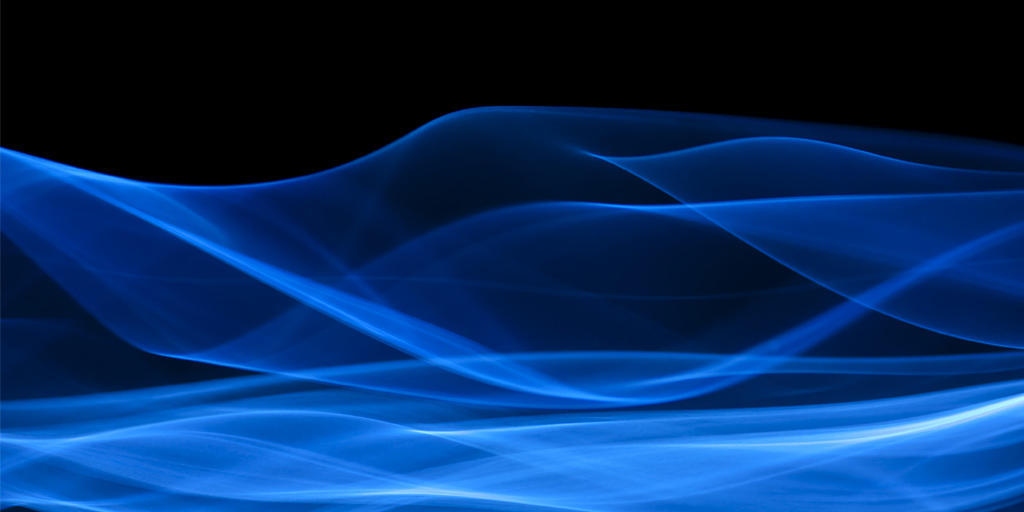 Abstract blue smoke against a black backdrop
