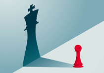 A red Pawn chess piece with a shadow that forms the shape of a King piece