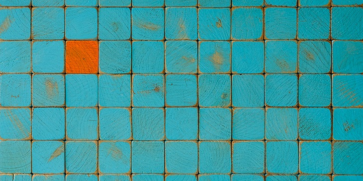 A collection of blue tiles, with one orange tile in the middle